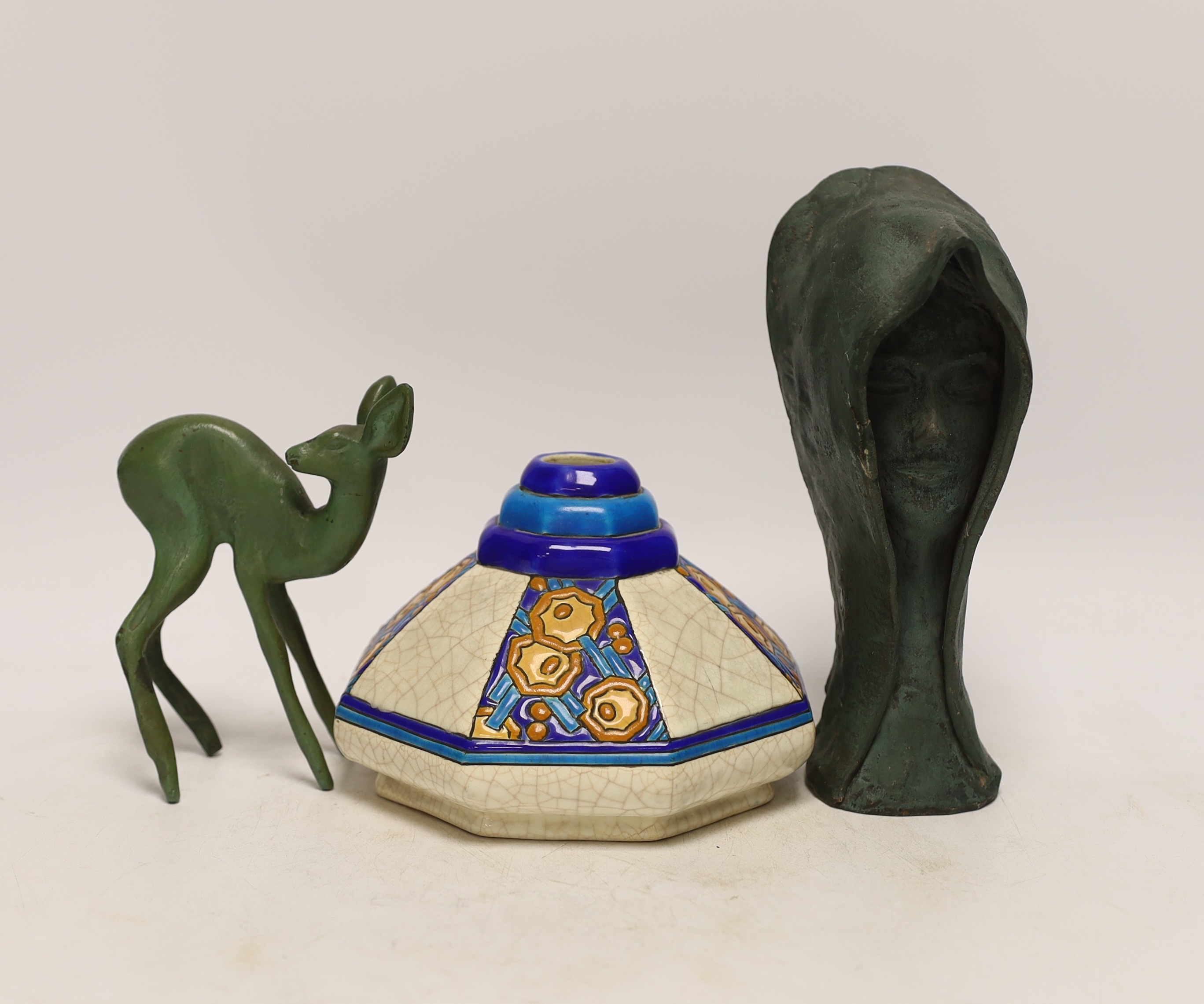 An Art Deco bronze deer, signed, a Longwy vase and a pottery head with hood (3)